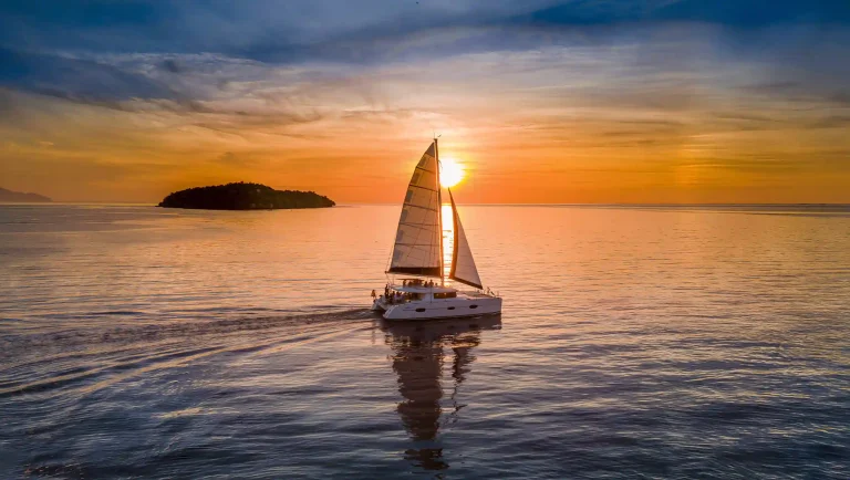 Sailing catamaran at sunset in Komodo National Park