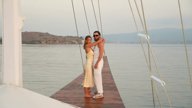Couple embracing on a sailing yacht in Komodo