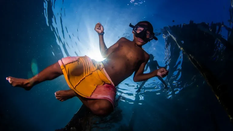 Local community member snorkeling near the village